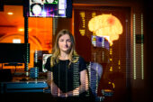 A woman sitting with data overlaid over the image