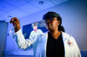 A student wearing a white coat and a virtual reality headset