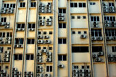 This image shows an urban housing unit with many air conditioning and heating systems.