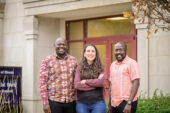 The team standing outside the entrance to the School of Social Work building on the U. of I. campus.