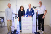Professors Mani Nakamura  and John Erdman, along with team members Nouf Alfouzan and Catherine Applegate, standing with scales.wi