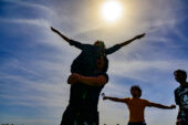 Aarya Mehta gets hoisted up as he throws his arms out to the eclipse as members of the Illini Astronomical Society celebrate witnessing the historic total solar eclipse