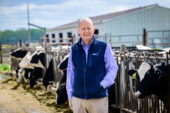 Photo of Dr. Lowe standing near a cattle feed lot.