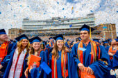 Graduates celebrating at May 2022 commencement in Memorial Stadium