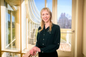 Portrait of Rebecca Walker standing in front of a window with the exterior of Temple Buell Hall behind her.