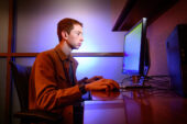 Production analyst and U. of I. student worker Josh Weiner enters information into the SPOTLITE database.