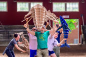 Photo of Deke Weaver and other performers holding whale puppets.