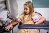 Margo Schiro, 7, gets her blood pressure taken.