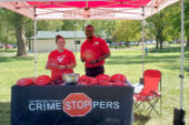 Crimestoppers tent in a park in Champaign-Urbana