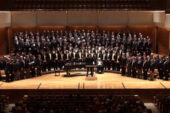 Photo of the Varsity Men's Glee Club on stage.