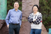 Portrait of researchers standing outside a campus building.