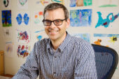 Dr. Martin Burke sits at a desk.