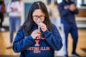 An Illinois student provides a saliva sample for a COVID-19 test.