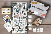 Image of a board game with cards, instruction manual and dice