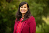 Portrait of Aditi Das standing outdoors.