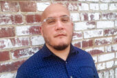 Headshot of Angel Garcia with a brick wall background