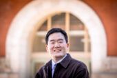 Portrait of Junghwan Kim outside a university building.