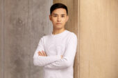 Portrait of Fan Xuan Chen. He is standing with arms crossed.