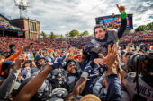 Bedlam unfolds as Illinois fans celebrate a major upset victory over heavily favored Wisconsin.