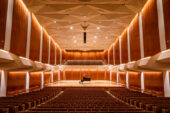 A large theater with a piano onstage