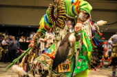 A Native American dancing in full regalia