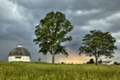 Summer storm clouds near a Round Barn and South Farms.