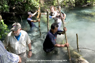 The team shuttles gear across the confluence of two creeks.