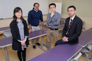 A team led by social work professor Kevin Tan, right, found in a recent study that girls are more likely than boys to struggle with significant academic, behavioral and social needs than boys during eighth and ninth grade. The team, left to right, includes graduate students Esther Shin, Gaurav Sinha and Yang Wang.