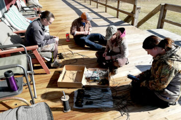 The crew spends an afternoon preparing GPS transmitters with cords that will be tied to turkeys.