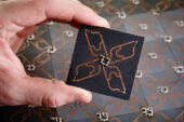 A single circuit board, foreground, that when joined with others forms the experimental array of the quadrupole topological insulator.