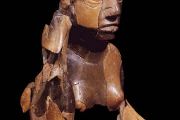A new exhibit includes the upper torso and head of a red goddess sculpture, carved from stone and found buried at the ancient American Indian city of Cahokia. Note the serpent wrapped around her head. This artifact dates to the 12th century.
