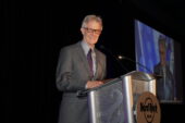 Michael Darter speaks behind a lectern.