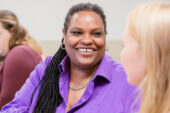 Journalism professor Janice Collins, advising students in a Hear My Voice meeting, said she started the website and organization to provide "a platform where we can all come together to learn."