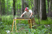 Researchers, including Parkland College student Kaleb Cotter, sift through materials uncovered in excavations of native mounds in Robert Allerton Park.