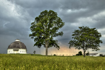 A summer storm near one of the Round Barns on the South Farms.