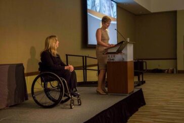 Jean Driscoll in a wheelchair on a stage