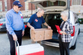 Special delivery Volunteers load a meals into a vehicle parked outside the Illini Union in preparation for delivery to the homes of Meals on Wheels clients. The "celebrity" volunteers delivered meals on Sept. 18 as part of an event honoring Dining Services' 45 years of participation with the Meals on Wheels program.  Click photo to enlarge