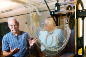 Bruce Hannon, a UI geography professor, shares the story of the Urbana campus's 1878 tower clock, now housed in the mechanical engineering laboratory, during a recent tour of historic campus clocks. Hannon, who restores clocks as a hobby, will offer tours of the campus clocks this fall.