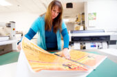 Pre-press technician Elizabeth Bowden prepares an order at the UI's Document Services department. Barbara Childers, the department's director and Facilities and Services associate director, said the department will continue to offer most of its traditional day-to-day services - though not the higher-volume work such as letterpress printing, large offset production and some bindery functions. "By eliminating the services that we did, we now can be a more effective, one-stop provider," Childers said.