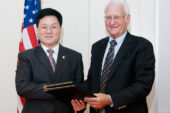 Global connections Robert Easter, right, dean of the College of Agricultural, Consumer and Environmental Sciences and interim provost, and Wenyu Han, president of Jilin University-Heping Campus, shake hands after signing an agreement that will facilitate research and teaching collaborations between the UI and Jilin in areas such as crop sciences, human nutrition and biotechnology.  Click photo to enlarge
