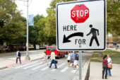 New signage was added at 29 campus crosswalk locations over the summer to reflect the state's year-old crosswalk law. Under the new law, motorists must come to a complete stop if a pedestrian has already entered a crosswalk. Pedestrians also are required to give motorists ample time to slow down and stop - or wait for a better opportunity to cross.  Click photo to enlarge