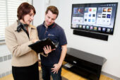 Christine Dietrich, the assistant director for the new Illini Union Tech Zone computer store, goes over store-opening preparations with UI student John Swinney, a store employee and technology consultant. The new 2,500-square-foot store, which will offer the latest computer equipment and advice on how to use it, has a grand opening planned for Oct. 26 that includes refreshments and prizes.