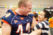 Austin Teitsma, a sophomore from Glen Ellyn, Ill., plays with a Garden Hills Elementary School student during a Hometown Heroes visit.