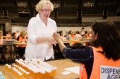 An ounce of prevention Jane Barham, an account technician in the Office of Financial Aid, poses as a patient to pick up medication during an emergency preparedness exercise at Assembly Hall on June 2. Barham and other volunteers helped UI and local emergency planning agencies test plans for distributing preventative medications to members of the campus community in the event of an infectious disease outbreak.  Click photo to enlarge