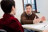 History professor and faculty mentor Craig Koslofsky illustrates the faculty-mentoring process during a recent session with English professor Kate Vieira. The new campuswide faculty-mentor program, which started last year, has already tripled in size and grown to nearly 100 participants.  Click photo to enlarge