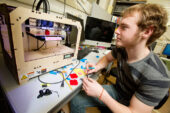 Sophomore Jason Hempstead uses a 3-D printer in the Illinois Geometry Lab to make solid shapes from plastic.