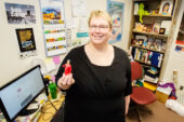 Laura Barnes, a librarian for the Prairie Research Institute and the executive director of the Great Lakes Regional Pollution Prevention Roundtable, shows off her librarian action figure, one of the many pieces in her office collection.