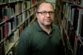 Jan Adamczyk, a senior library specialist, in between rows of books.
