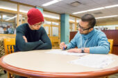 Yanchen Shi (left), a senior in bioengineering from Dunlap, Illinois, gets his resume reviewed at The Career Center by Rameez Siddiqui, a student paraprofessional there.