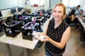 Nora Benson, a junior from Chicago majoring in engineering, displays a prosthetic hand created at the Illinois MakerLab.